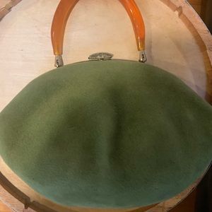 Vintage green clutch with amber color handle.